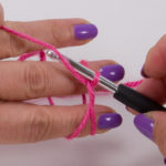 Now hook the thread above again and pull it through the loop on the hook.