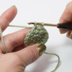 Insert into the next stitch and pull the thread through - there are two loops on the hook now.