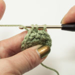 continue to pierce the following stitch and pull the thread through again - there are three loops on the hook now